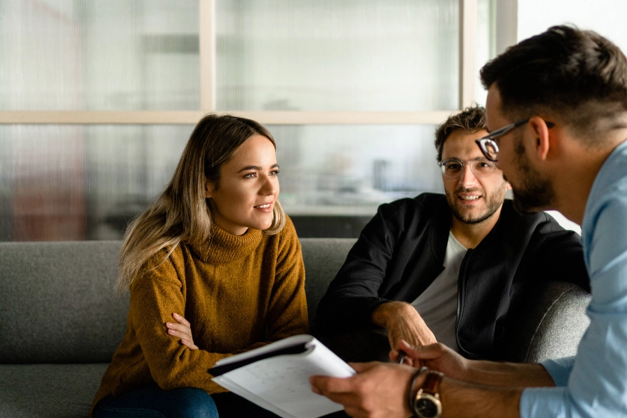 Three people discussing a project