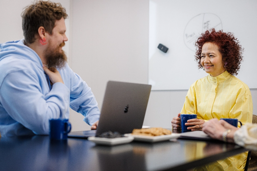 Man and woman talking in a meeting room
