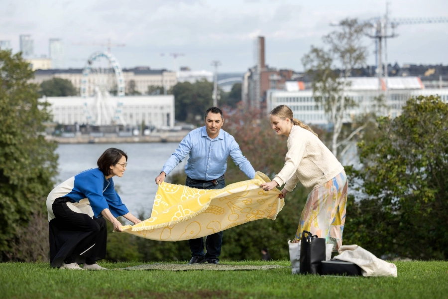 Three people having picnic at the park
