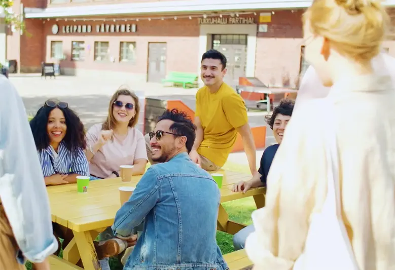 young people chatting on sitting in a park - Work in Finland, Visit Finland, Nina Vehmainen & Tommi Kortesniemi / Sherpa / Helsinki Partners, Iina Pihlman N2 Albiino / Helsinki Partners