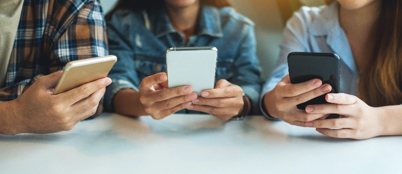 A group of people are using mobile phone