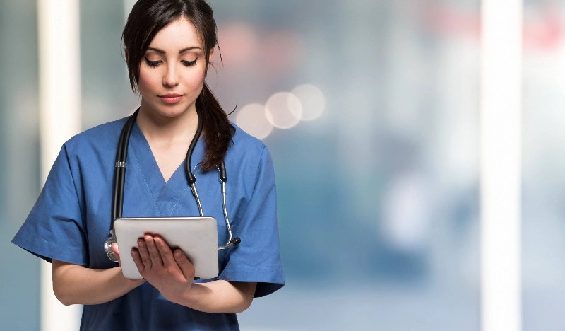Nurse checks information on a tablet computer.