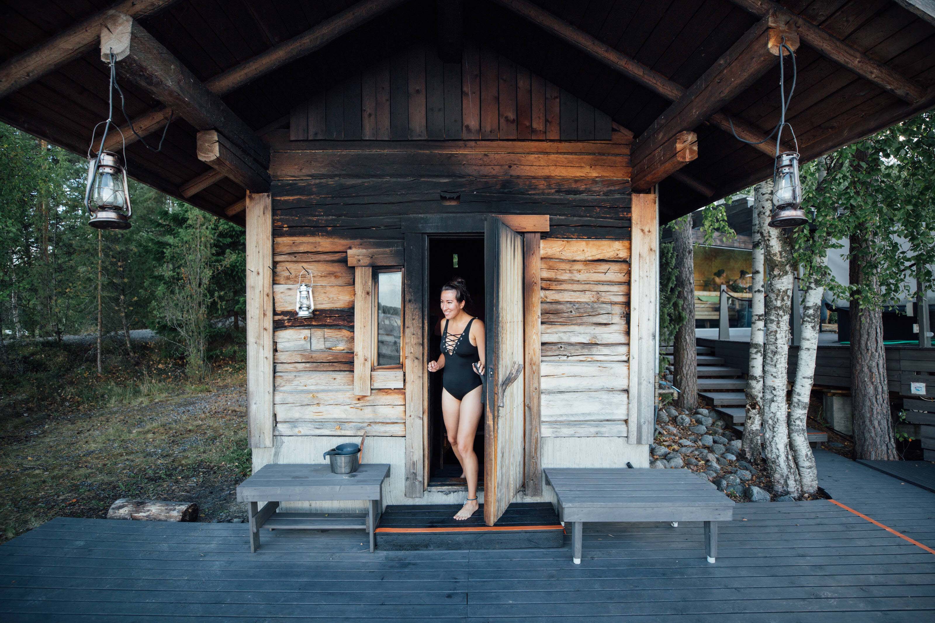 A woman stepping out of a hot smoke sauna.