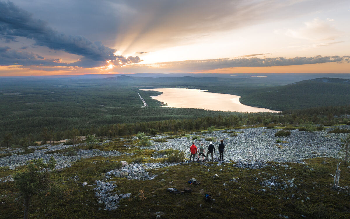 Group of hikers walking through the rugged landscapes of Pyhä-Luosto National Park, Finland. - Pyhä-Luosto