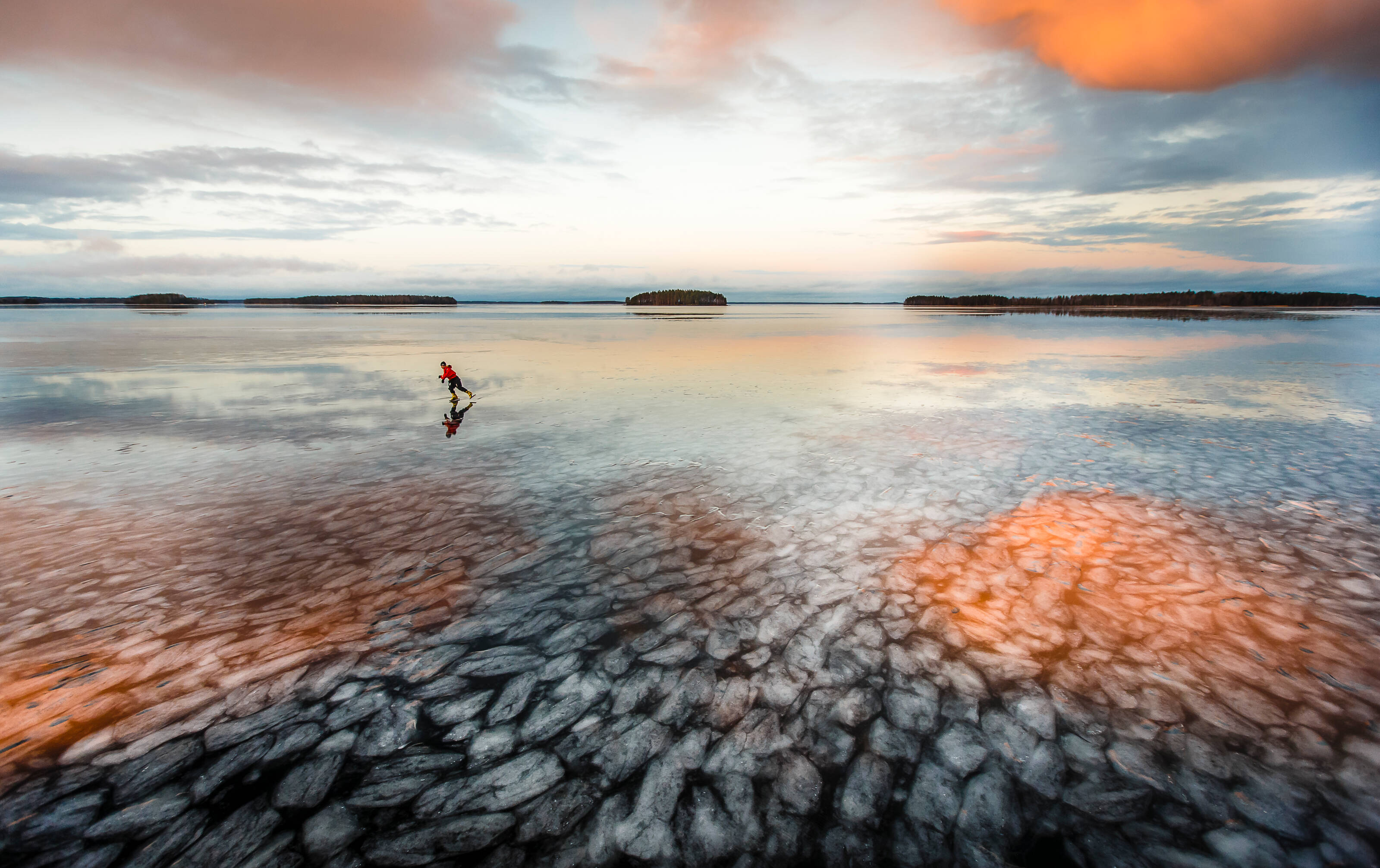 Person ice skating on a frozen lake in Saimaa, Finland.