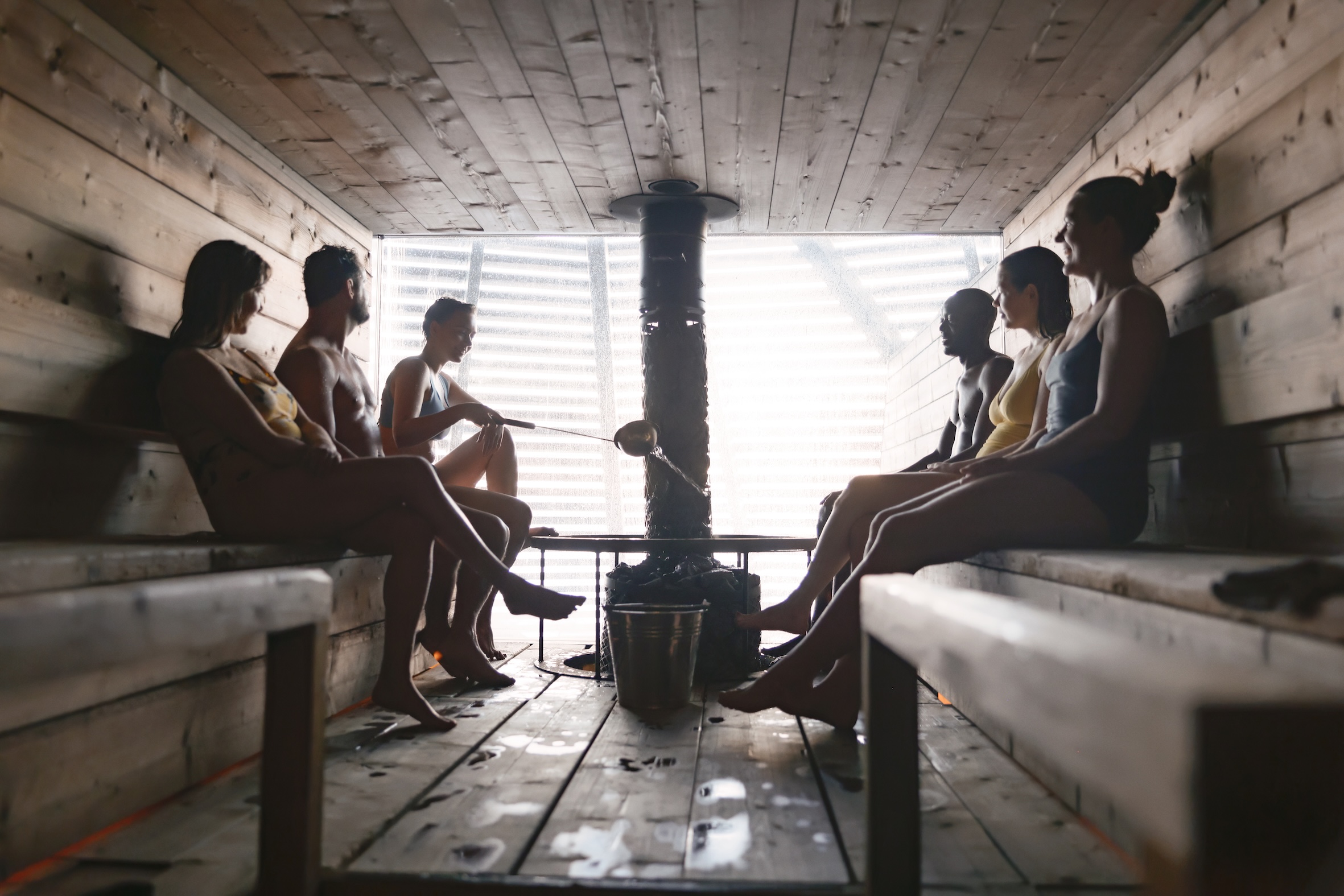 People sitting inside a sauna in Finland.