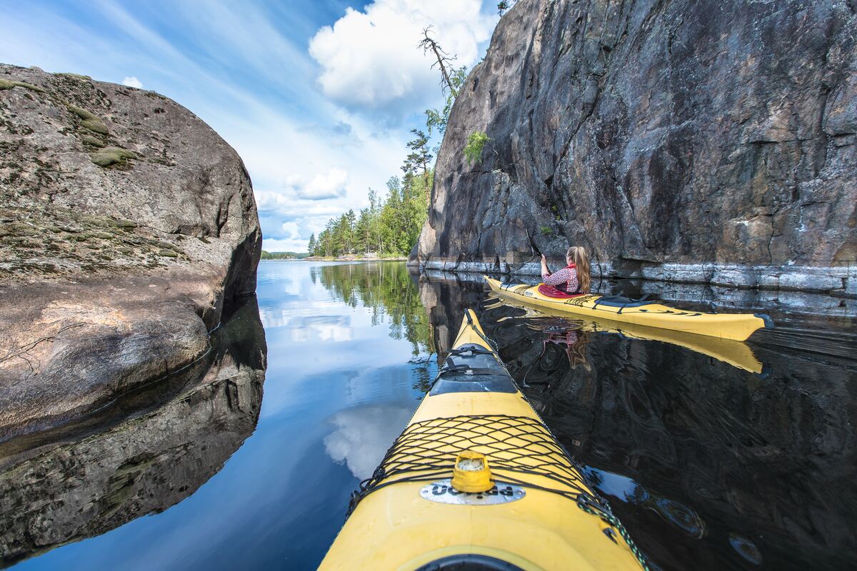 Two people in yellow kayak in Lake Saimaa, Finland.