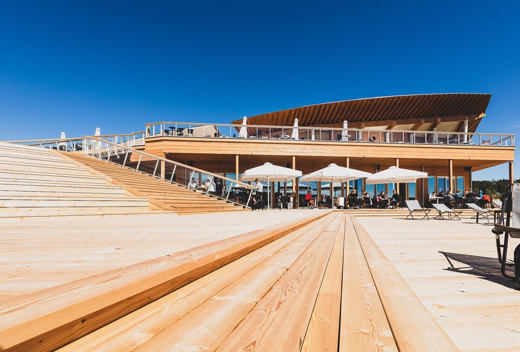 a huge wooden design terrace of a public sauna full of people