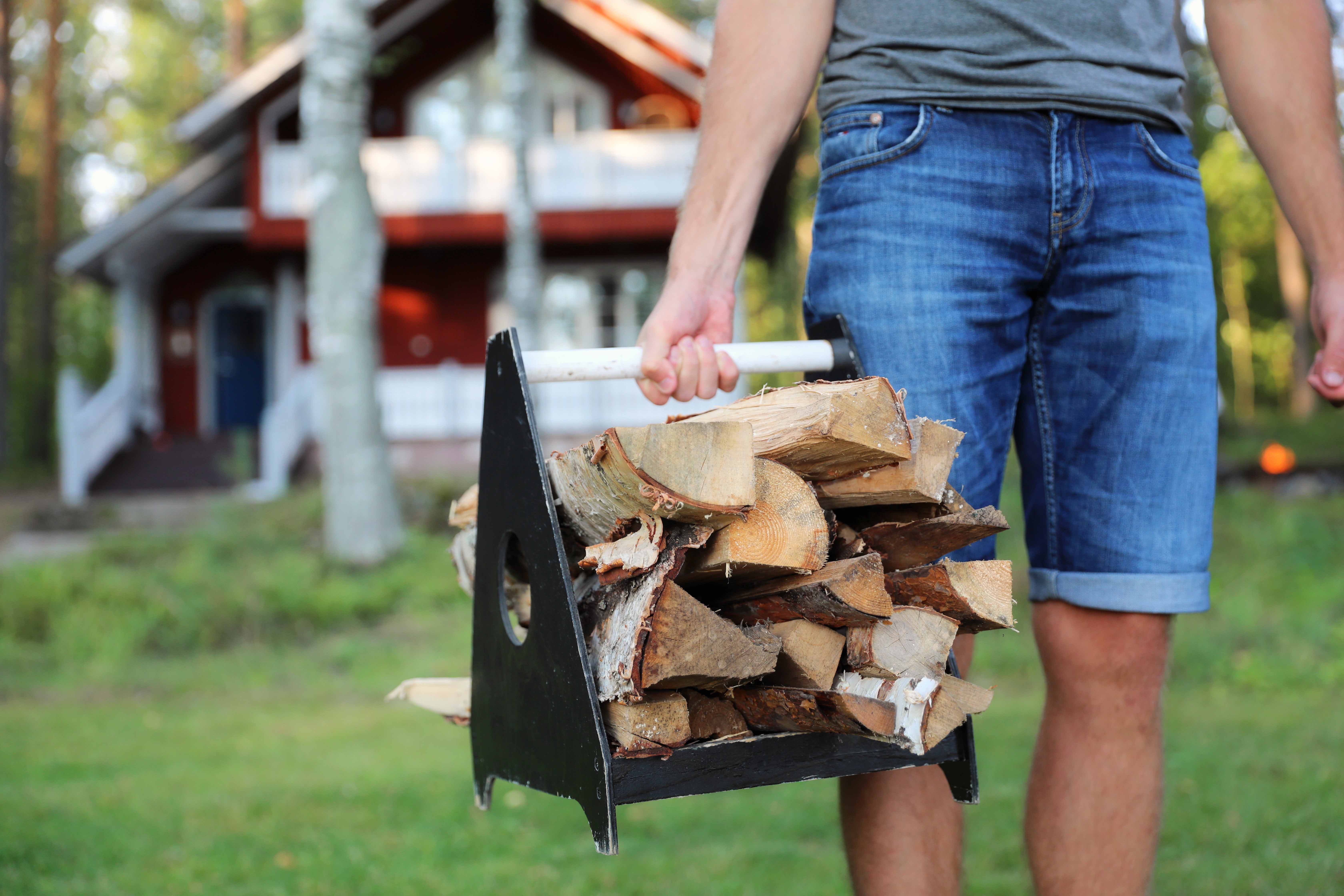 A man carrying firewood to the sauna.